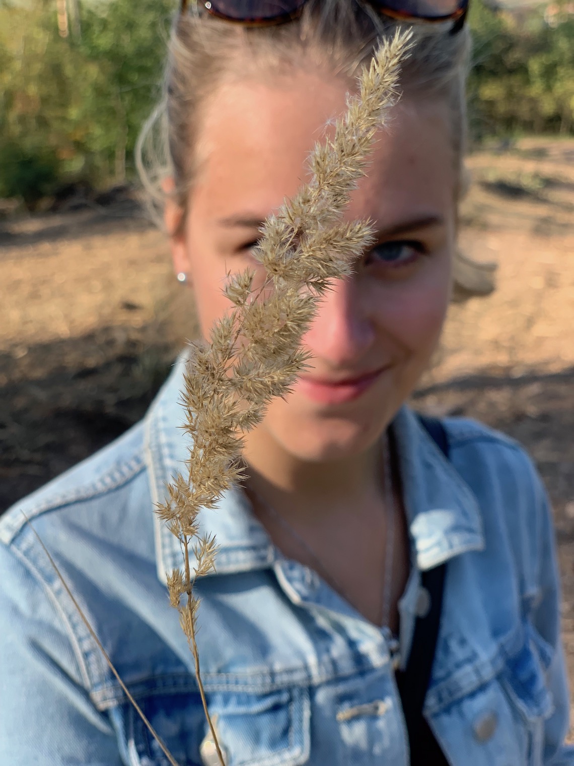 person with grass in focus