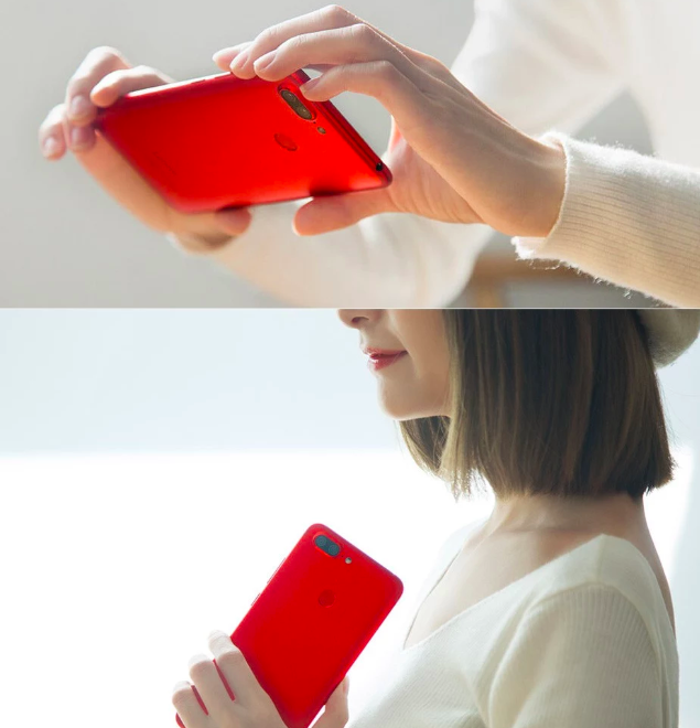 red smartphone in hand
