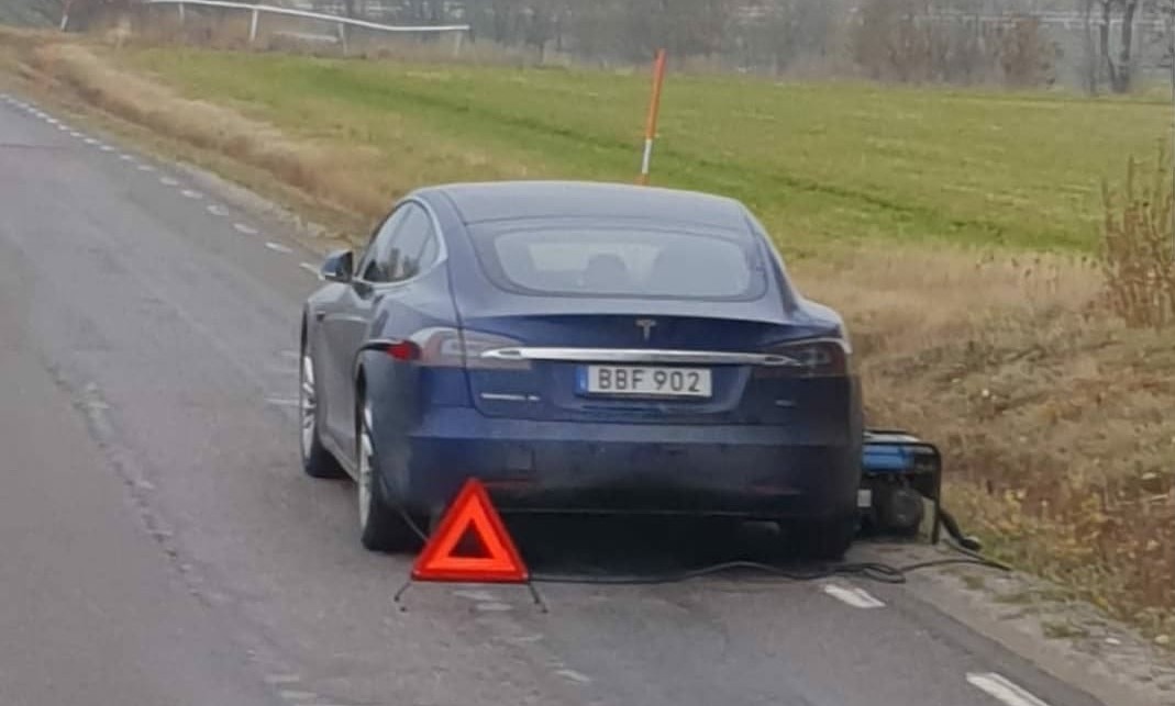 car on road with triangle warning
