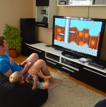 father son playing video games