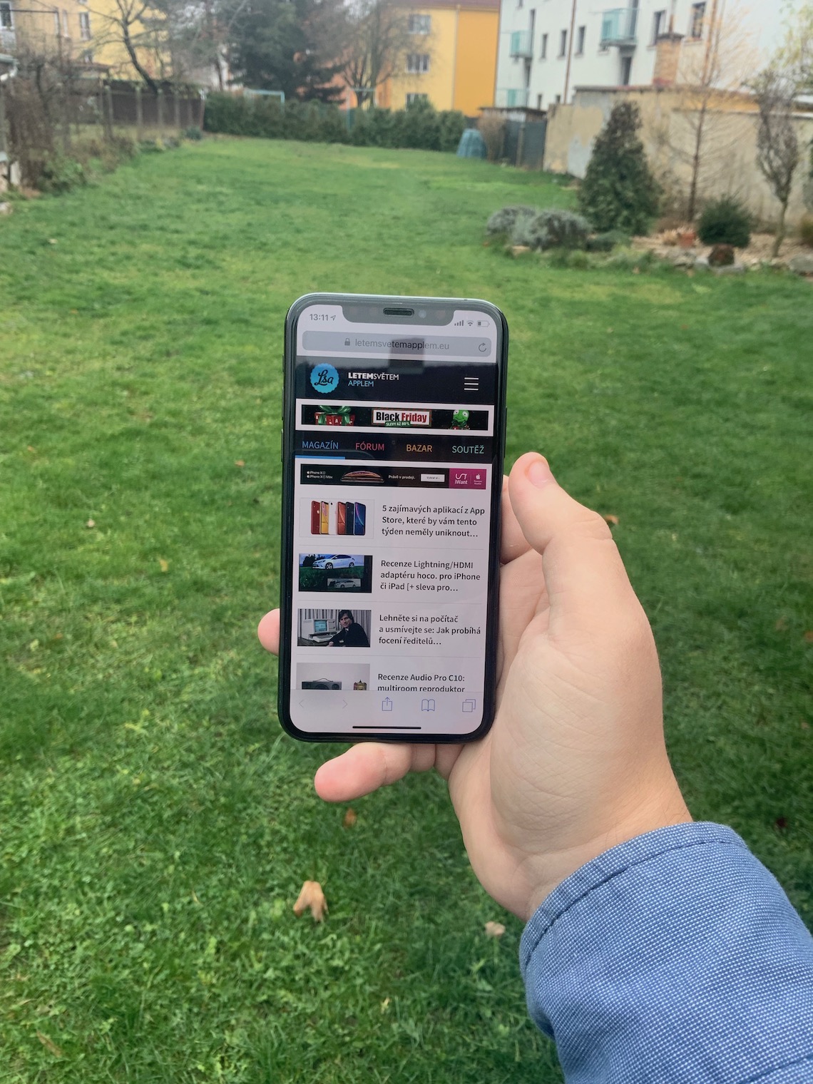 hand holding smartphone outdoors