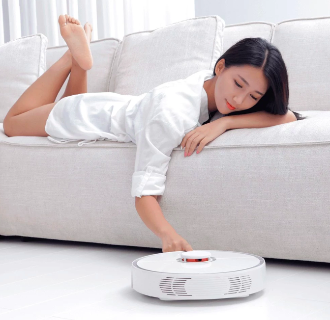 robot vacuum with person on couch