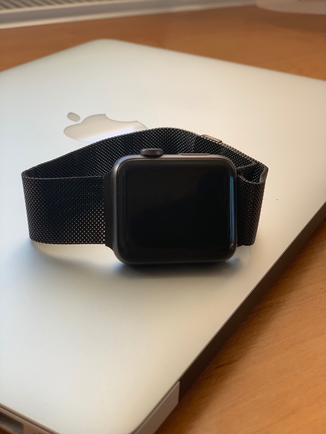black smartwatch on macbook