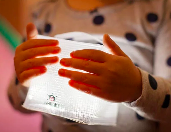 child holding light cube
