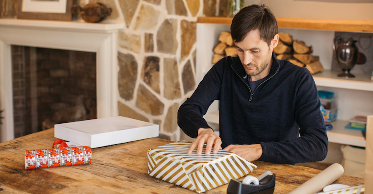 man wrapping gift