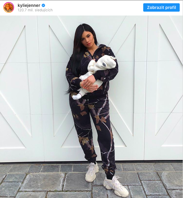 woman holding baby doll