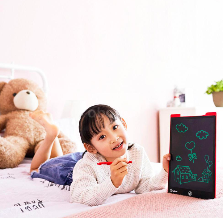 child drawing on digital tablet