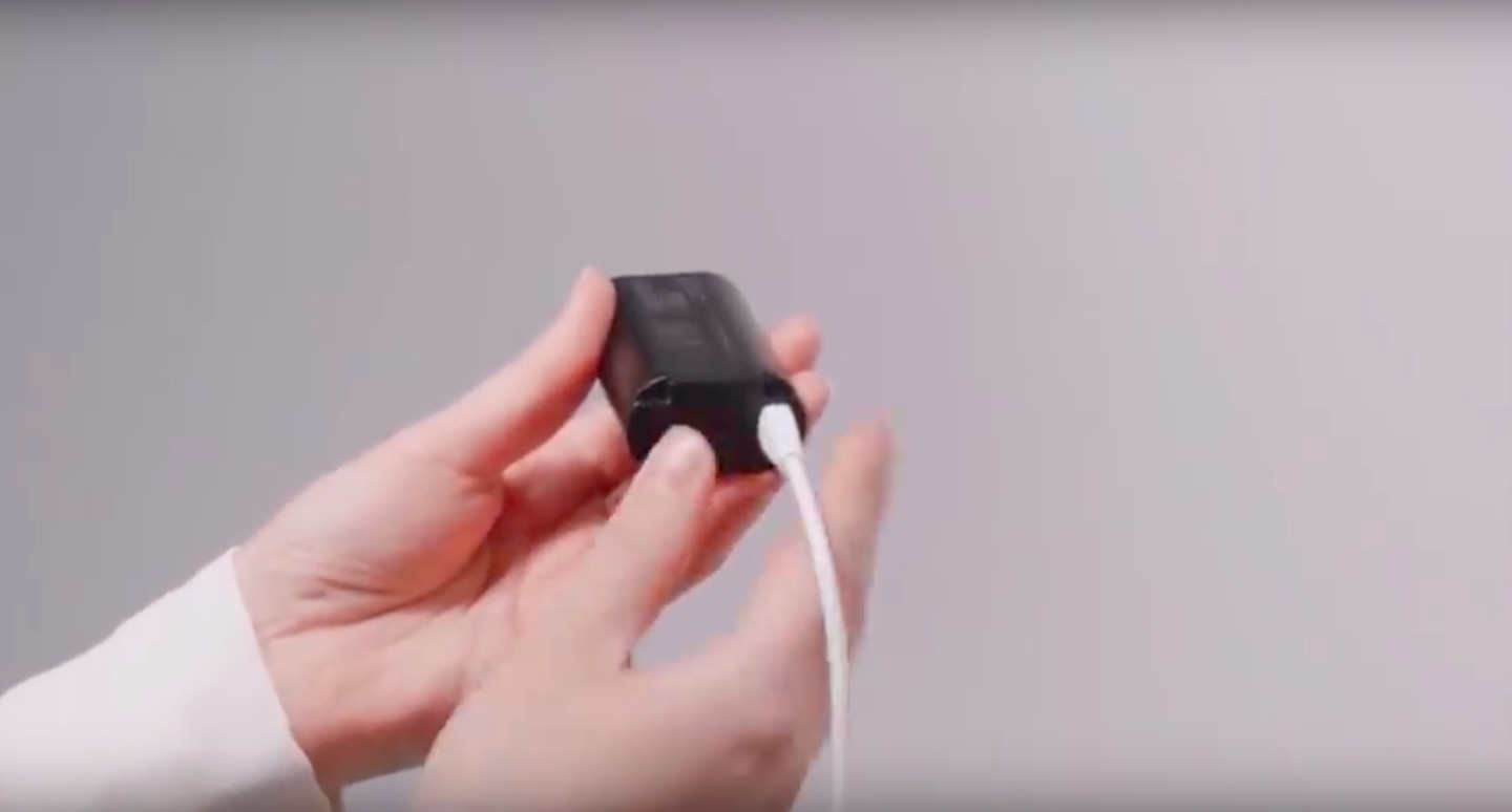 hand holding charging adapter