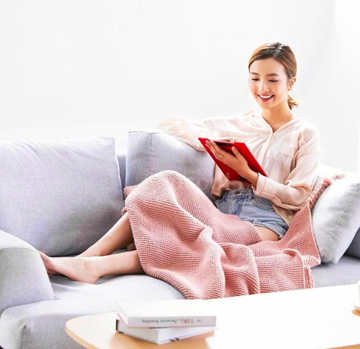relaxed woman on sofa with tablet