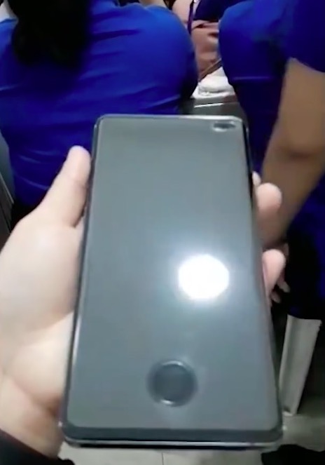 hand holding smartphone screen dark