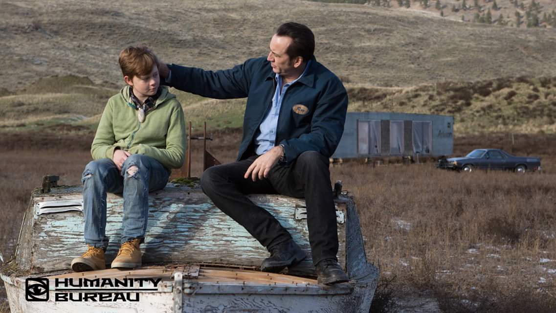 man and boy sitting outdoors