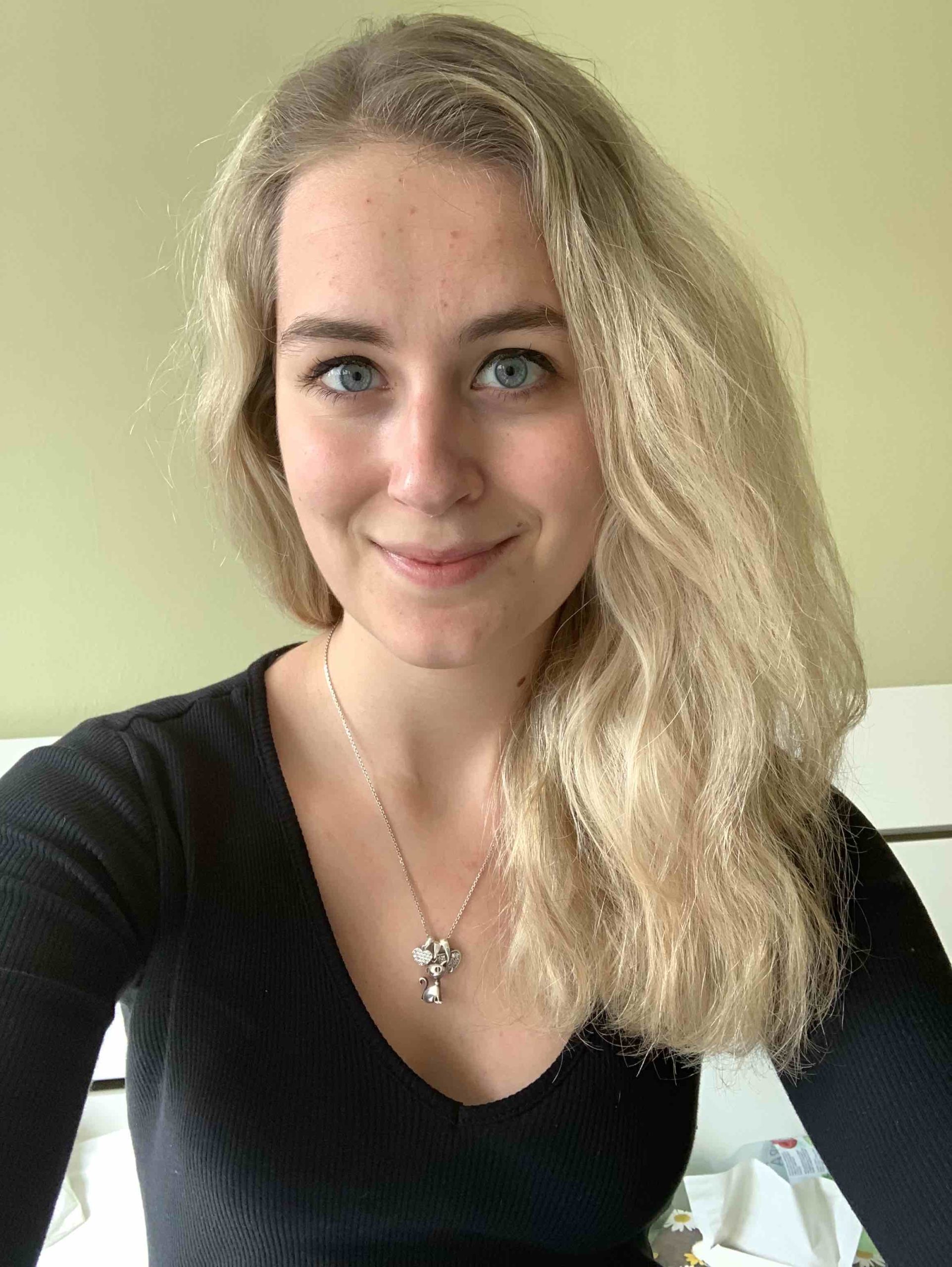 blonde woman necklace indoor smiling