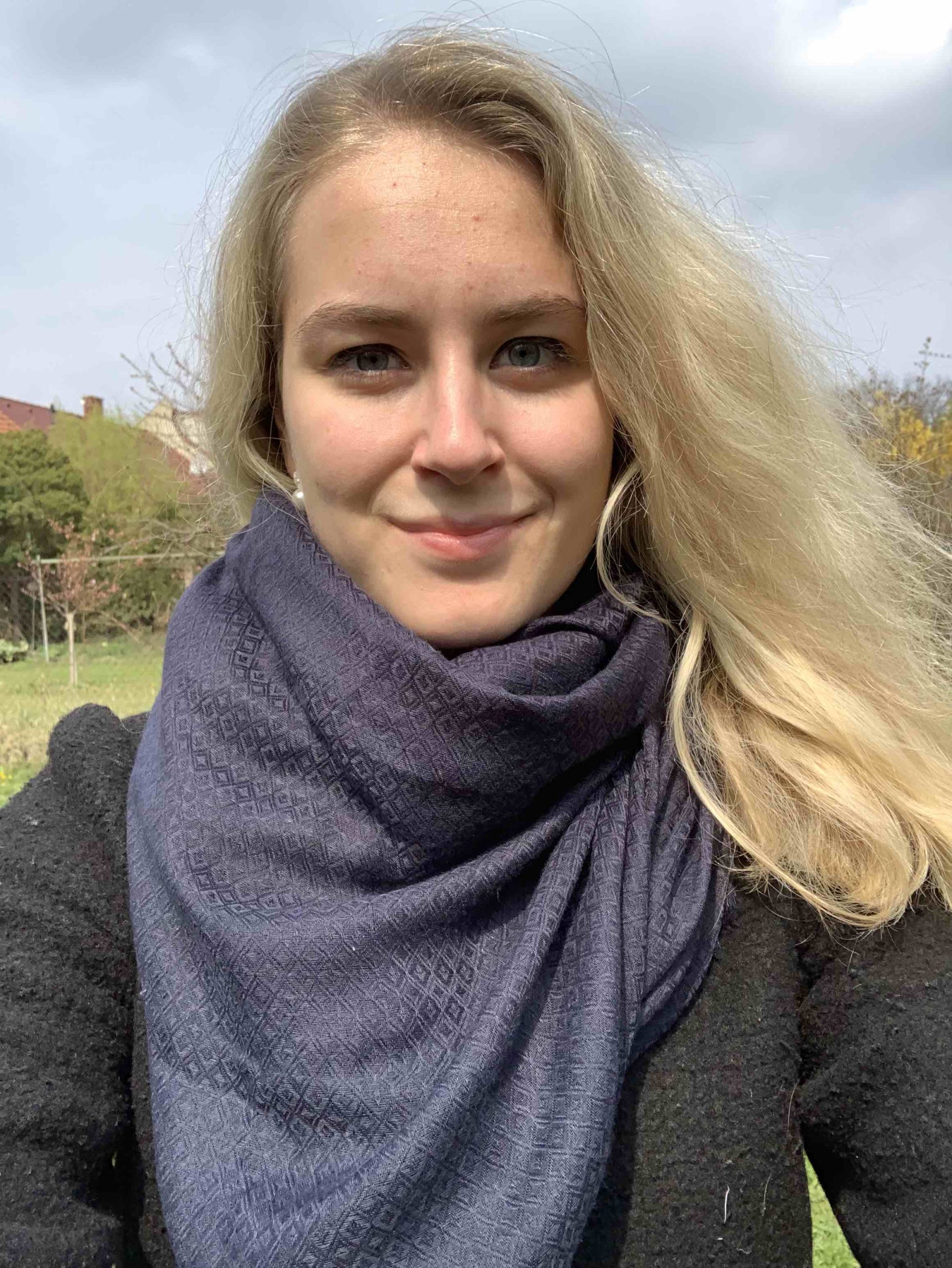 blonde woman scarf outdoor cloudy