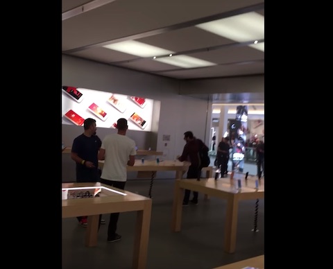 person damaging smartphones store
