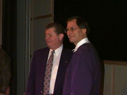 two men standing smiling