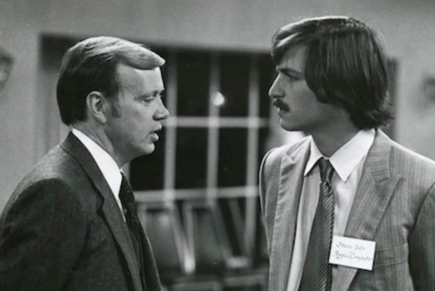two men talking formal attire
