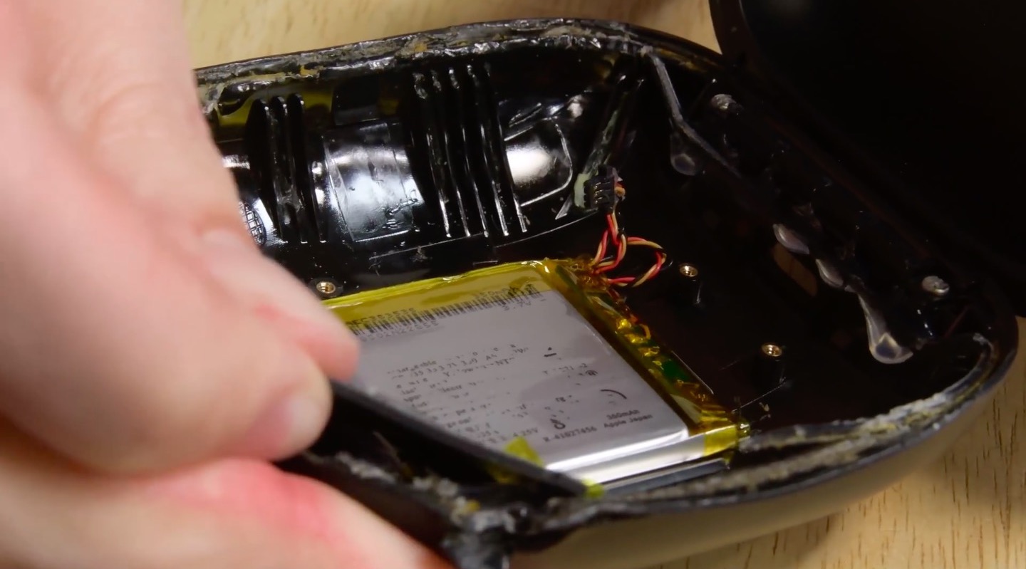 hand holding disassembled device battery