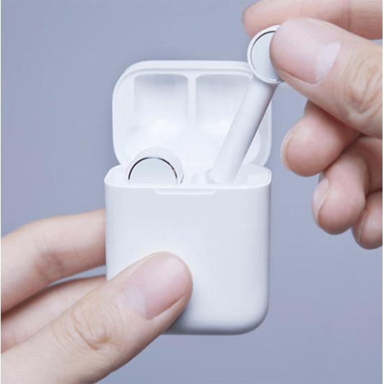 hand holding white earbud