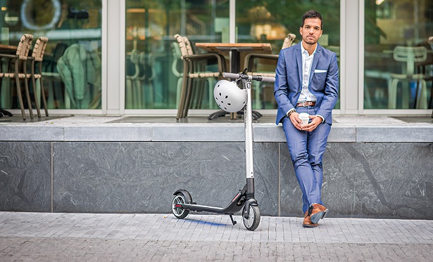 man with scooter and helmet
