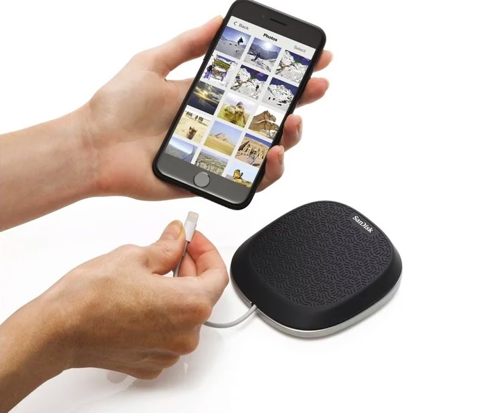 hand holding phone with sandisk base