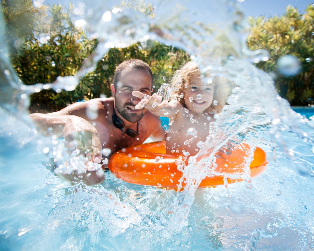 Child with father in swimming pool GoPro