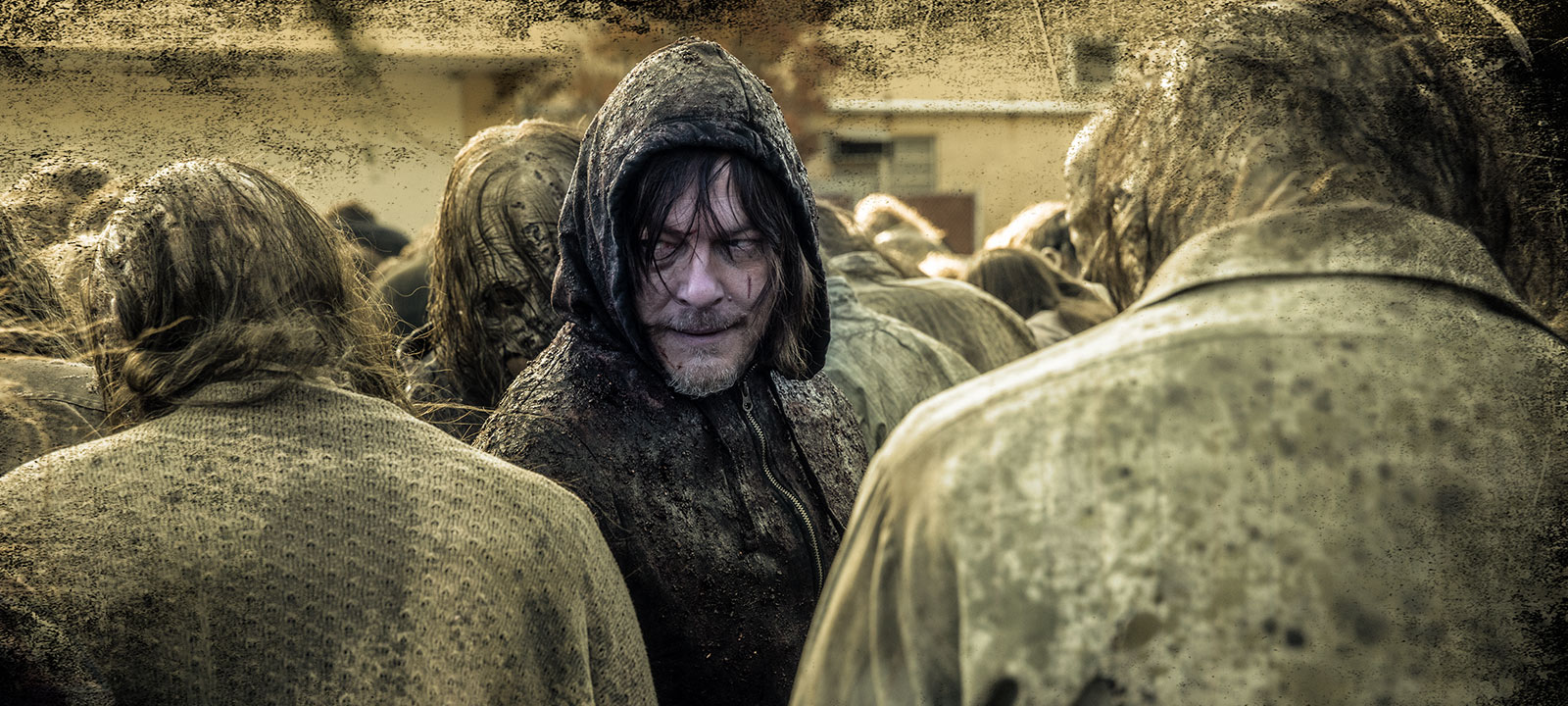 man in hood among zombies