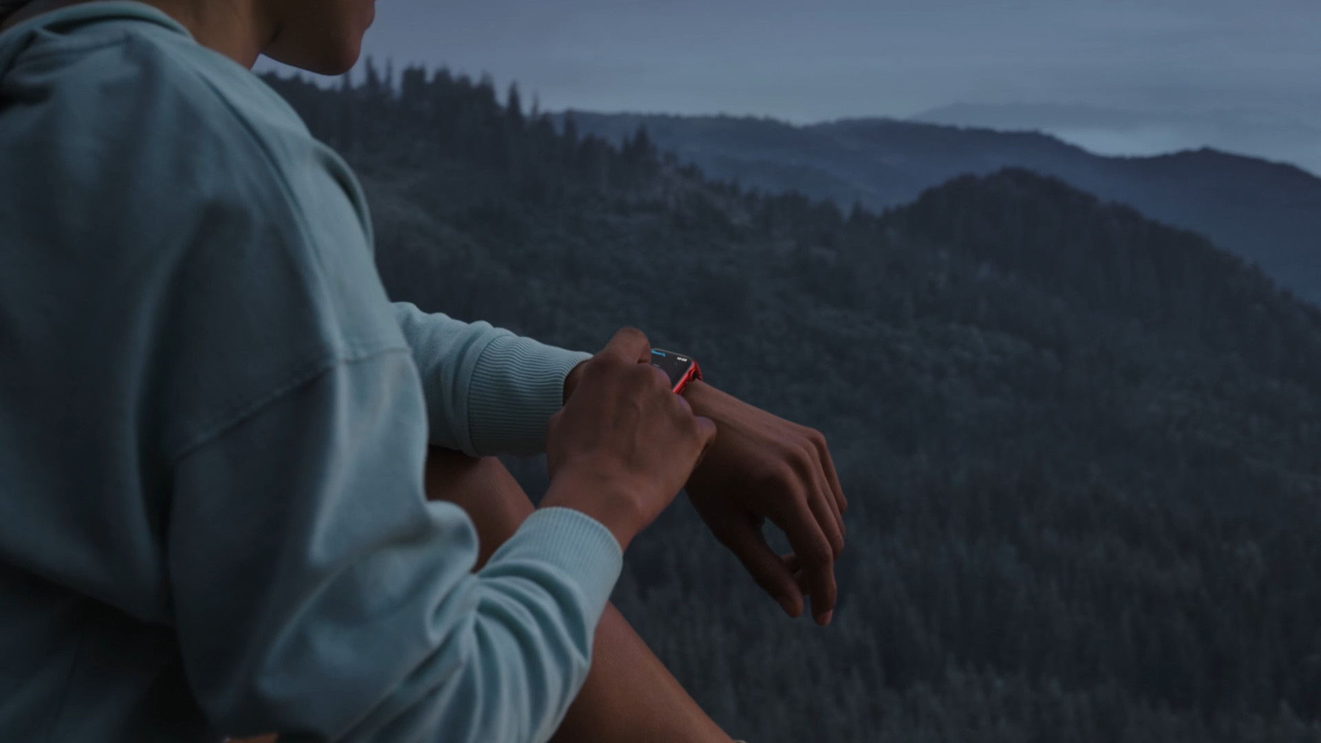 person checking watch in mountains