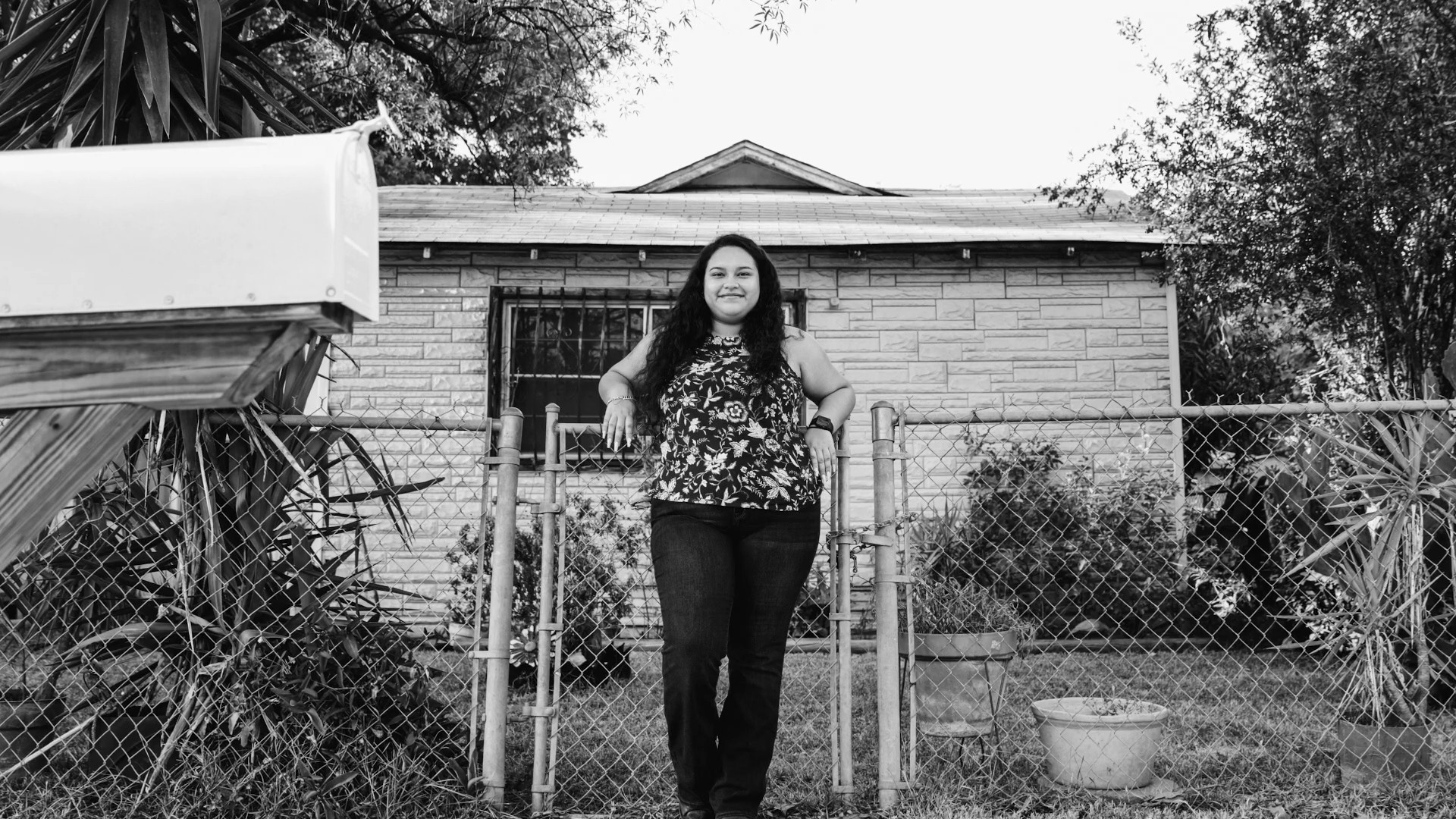 woman standing in front of house