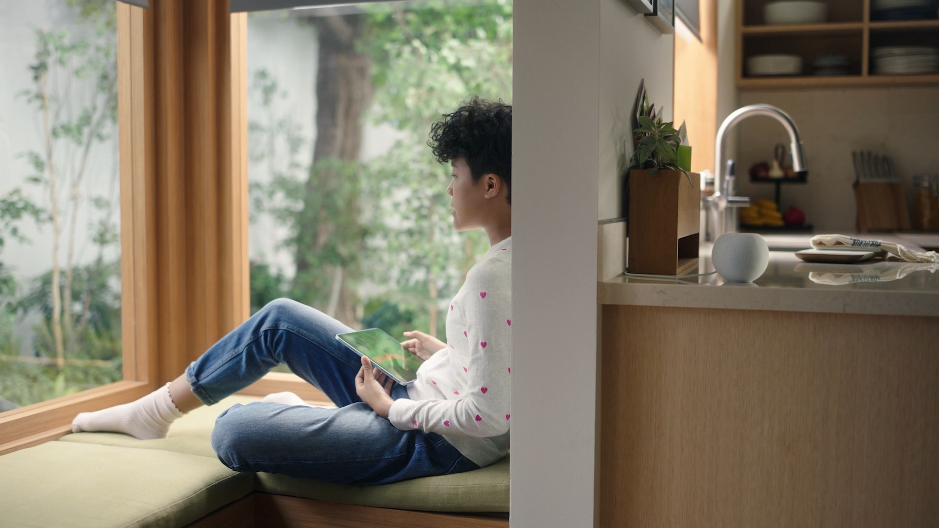 child using tablet near window