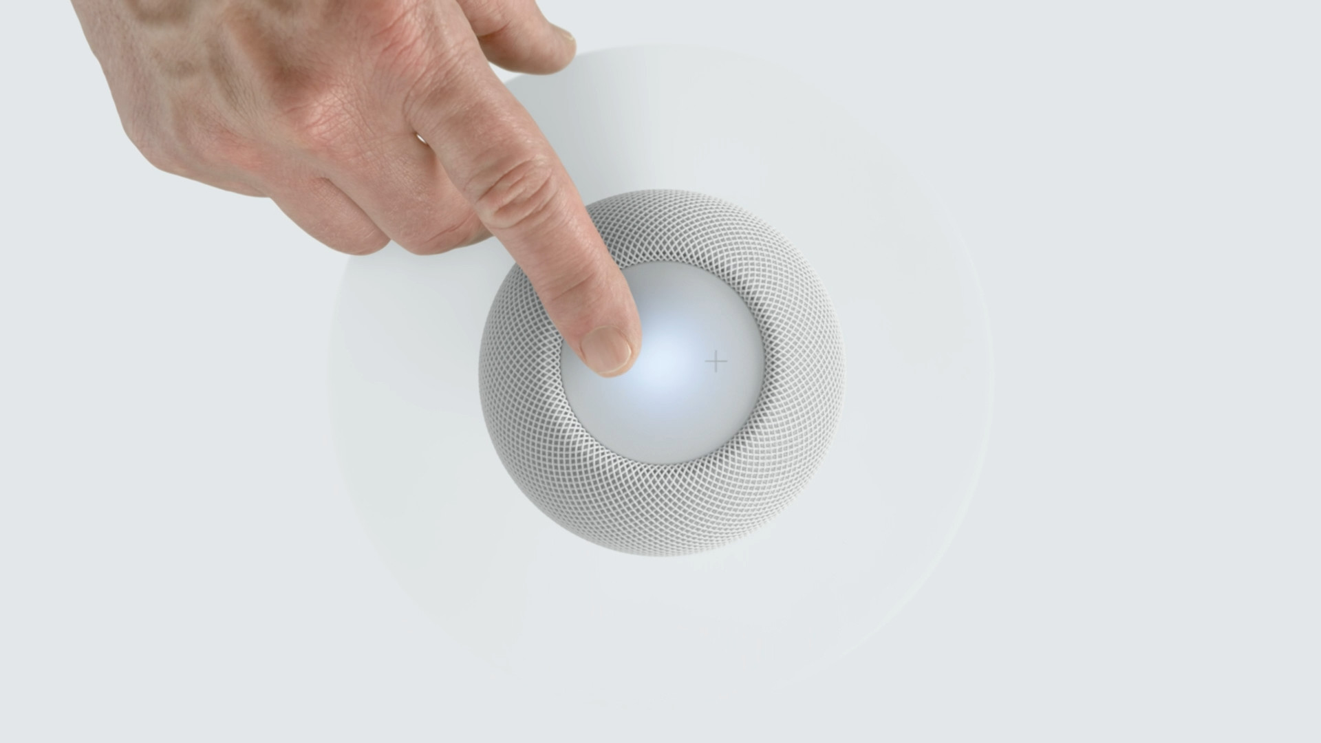 hand touching smart speaker