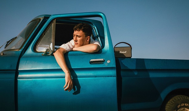 man in blue truck