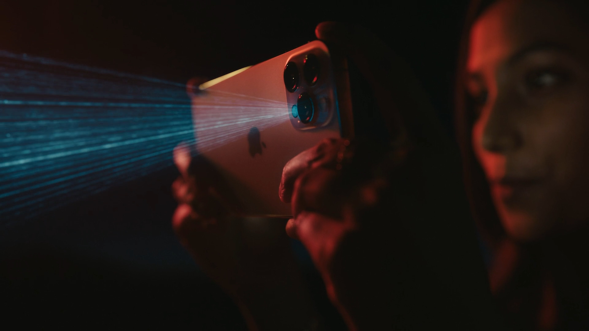 person holding iphone with laser 2