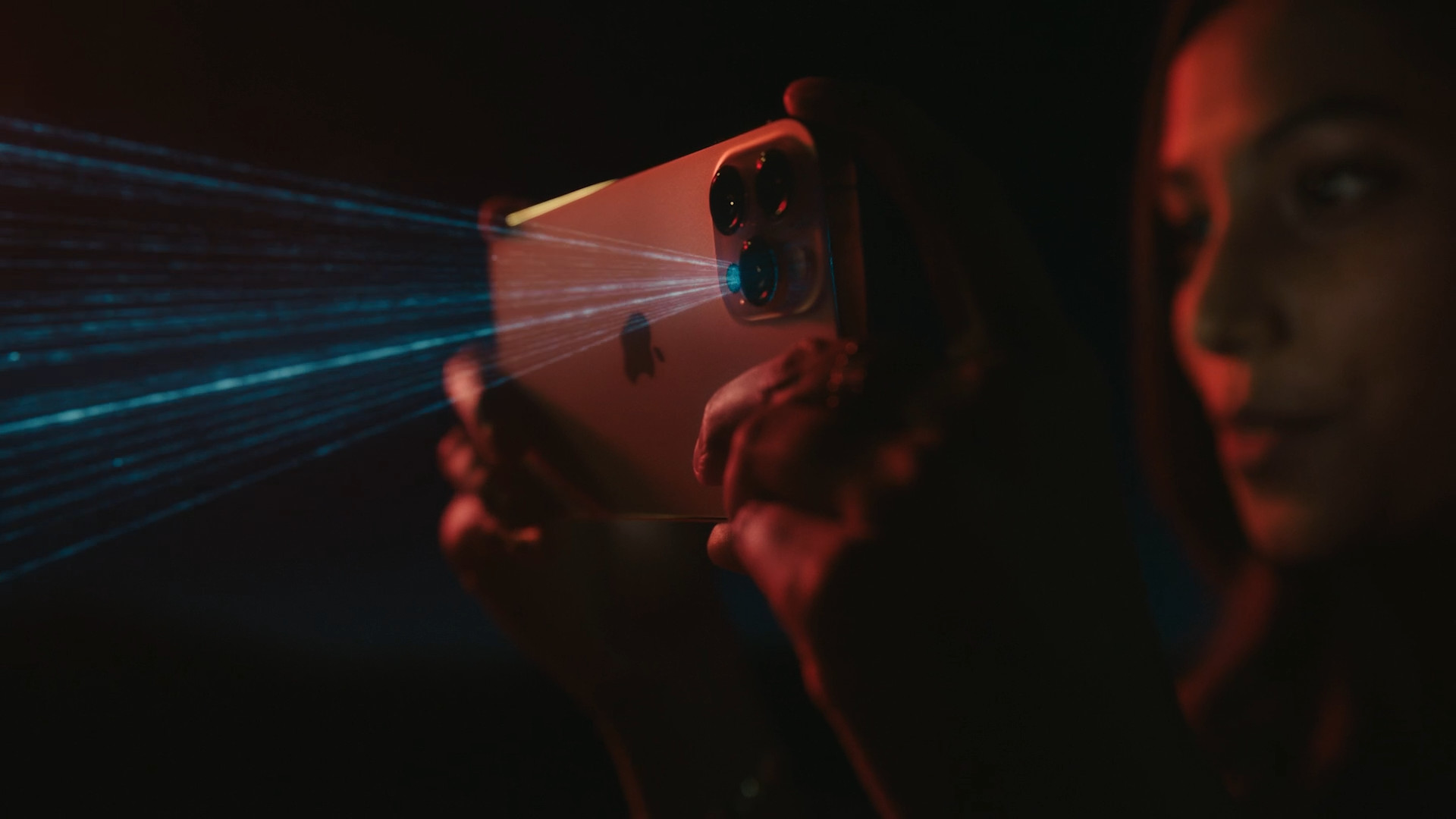 person holding iphone with laser
