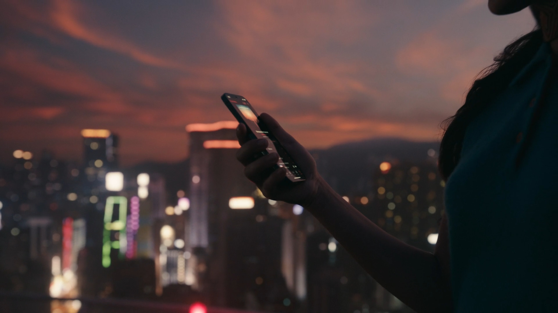 person holding smartphone cityscape
