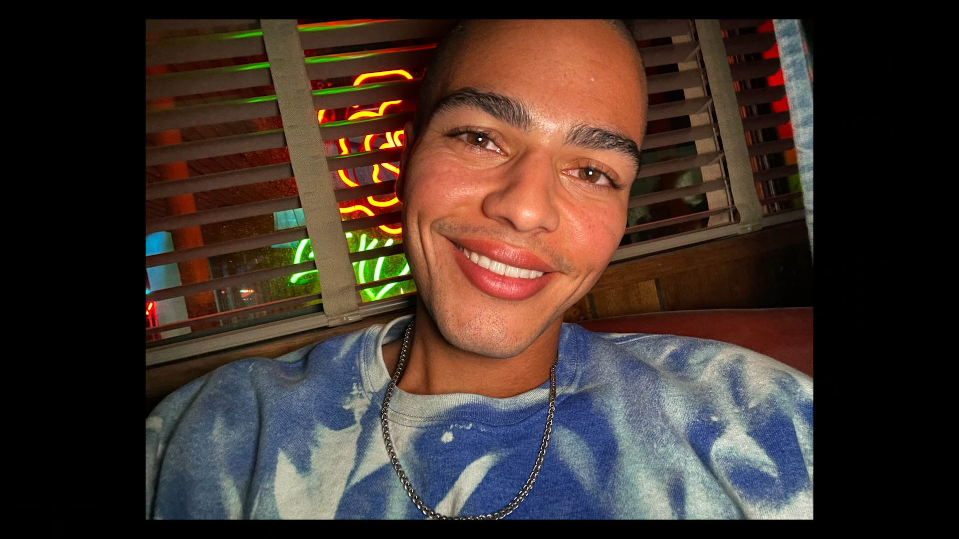 smiling person in neon light