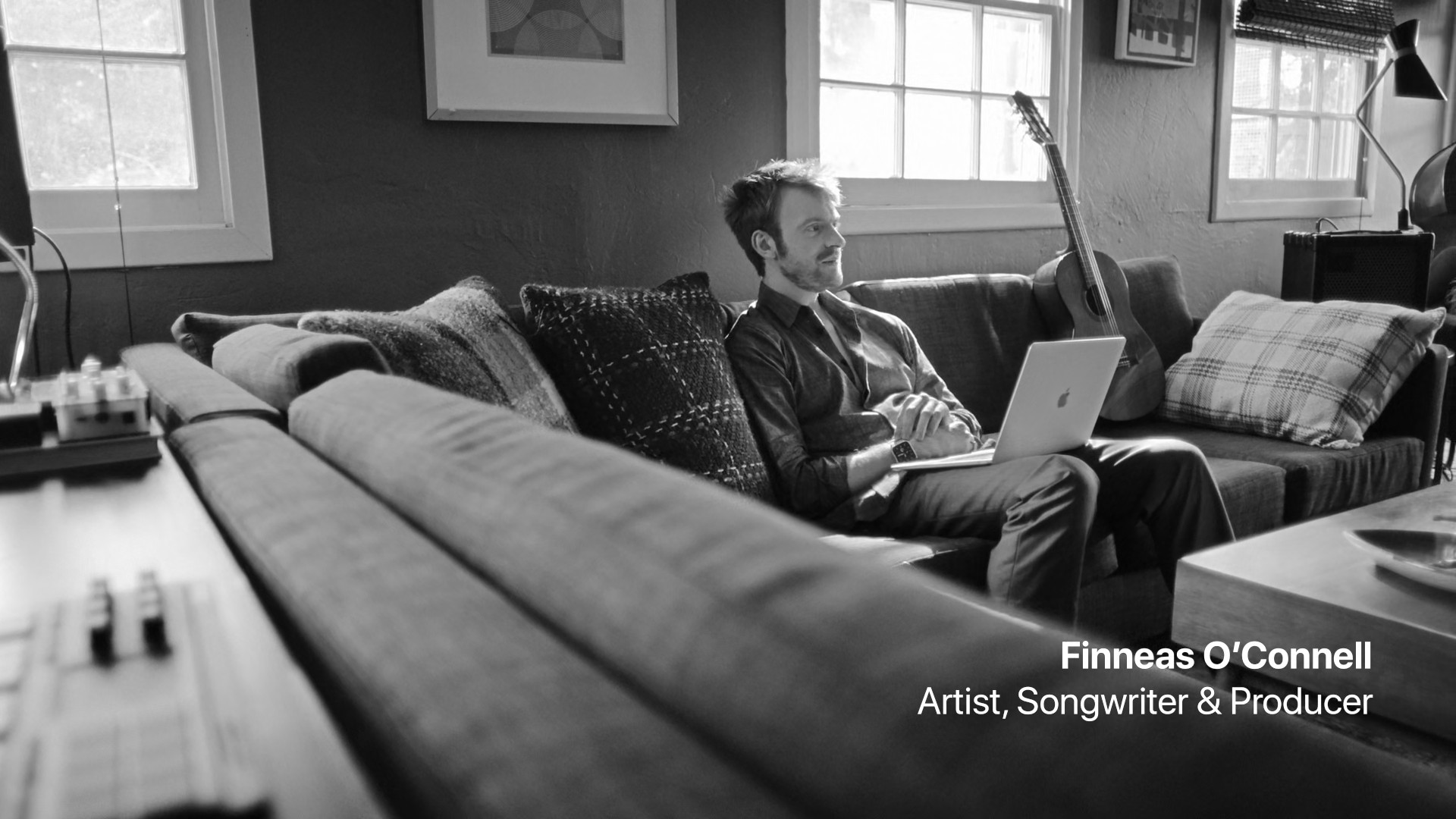 artist on couch with laptop