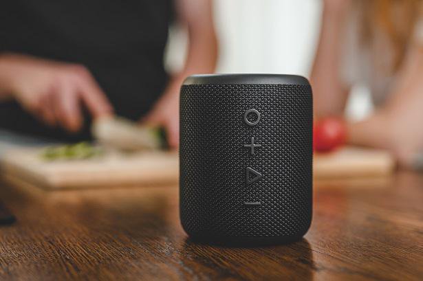 black portable speaker on table