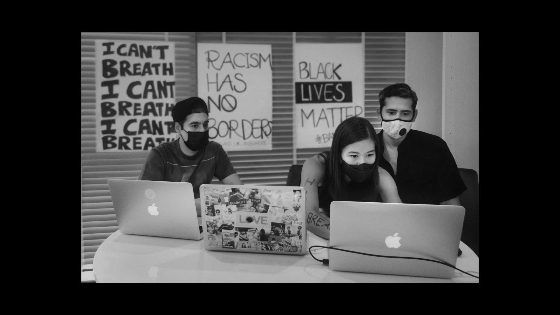 group with laptops and protest signs