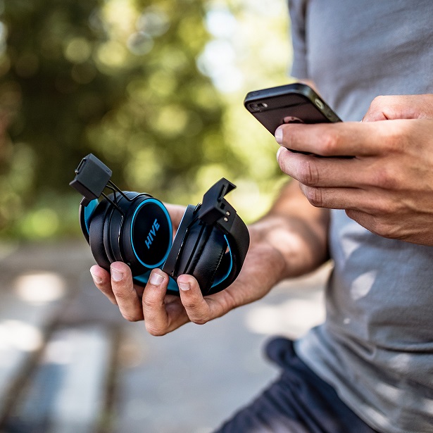 holding headphones and phone