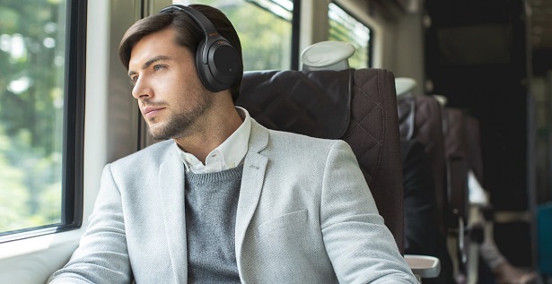 man on train with headphones