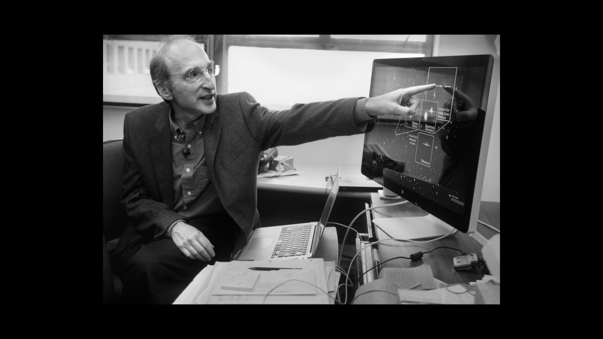 man pointing at computer screen