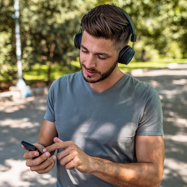 man using phone with headphones