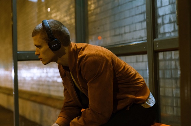 man wearing headphones bus stop