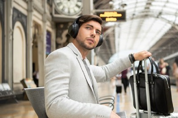man with headphones at station