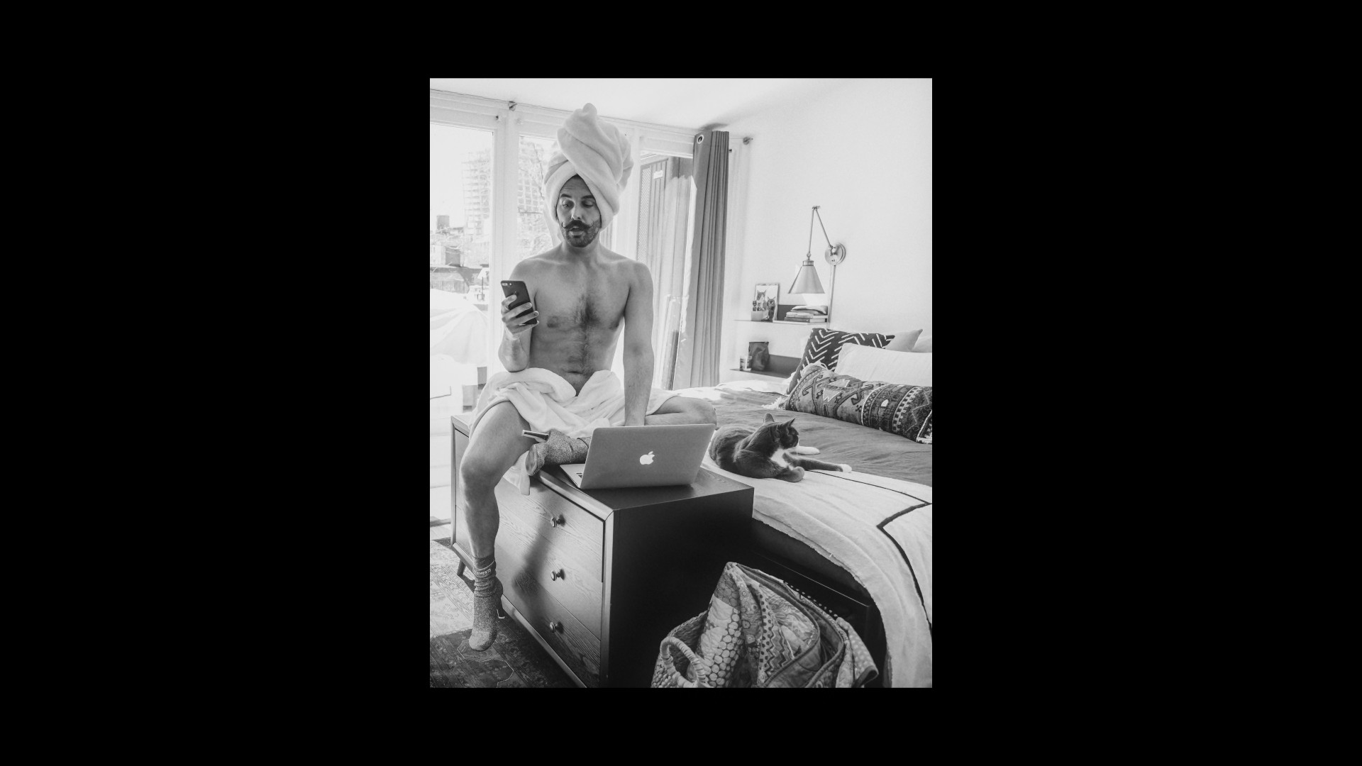 man with towel and laptop