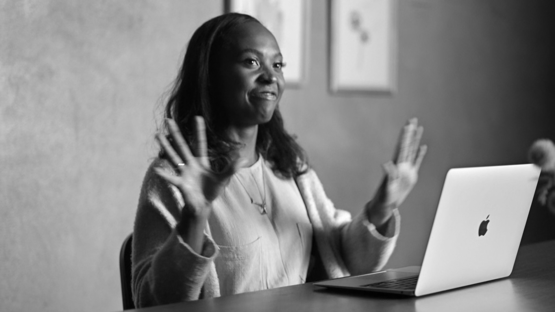 person gesturing with macbook