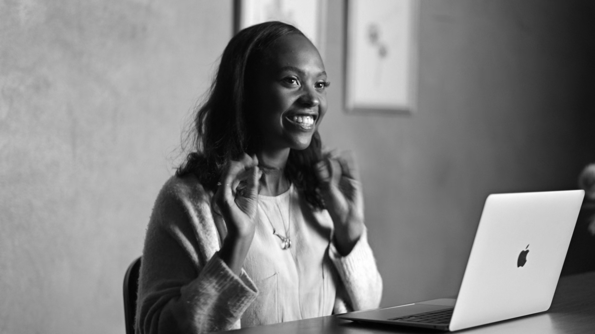 person smiling with macbook