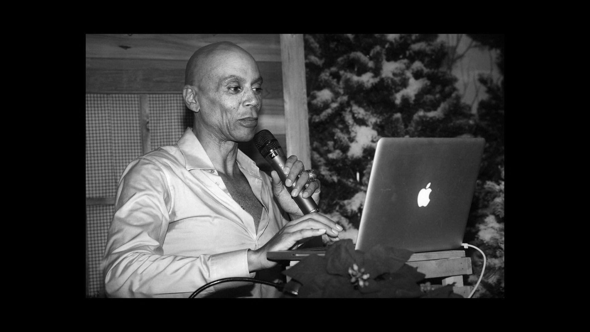 person with microphone and laptop