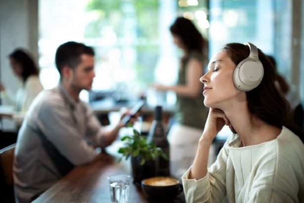 woman enjoying music in cafe