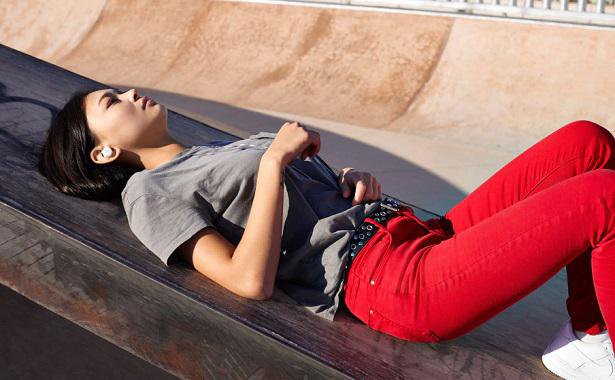 woman relaxing with earbuds on ramp